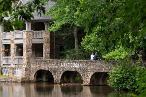 Socially distanced people on a bridge across Lake Susan.